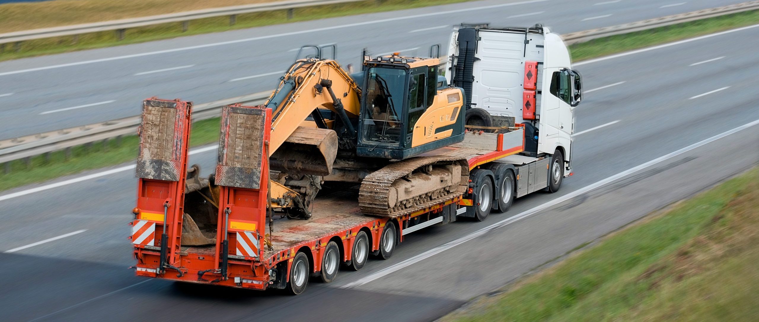 Heavy Machinery Equipment Transportation On Flatbed Trailer